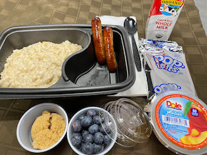 Hearty Oatmeal (Brown Sugar, Berries, & Pint Milk) with Sausage Links, Diced Peaches & Pop Tarts