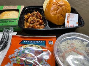 Pulled BBQ Chicken on Brioche Bun with Cole Slaw, Hawaiian BBQ Chips, Bag of Peanuts & Apple Pie