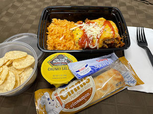 Hearty Beef Enchiladas with Spanish Rice & Tortilla Chips with Salsa, Sour Cream, Bag of Pretzels & Mini Cinnamon Rolls